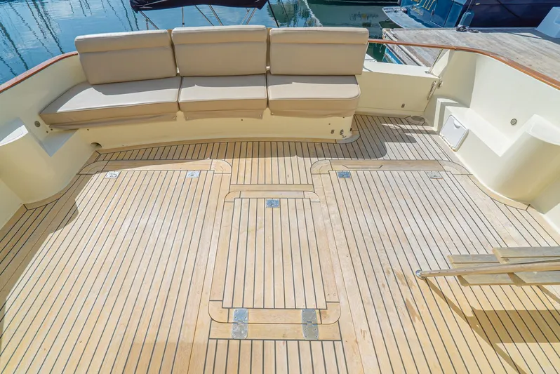 Nick Of Time Yacht Photos Pics Spacious deck of 2007 Midnight Lace Sport Cruiser with beige seating and wooden flooring.