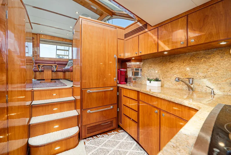 Nick Of Time Yacht Photos Pics Luxurious 2007 Midnight Lace Sport Cruiser interior with elegant wood cabinetry and modern amenities.