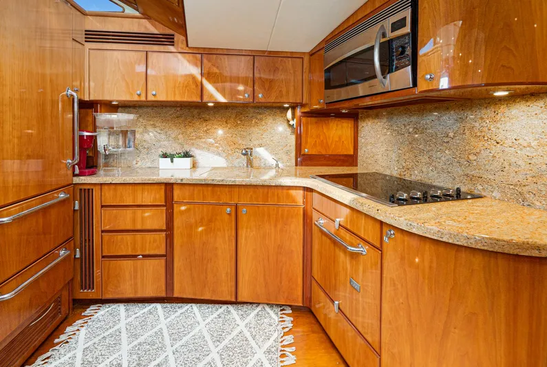 Nick Of Time Yacht Photos Pics Luxurious wooden kitchen interior in 2007 Midnight Lace Sport Cruiser yacht.