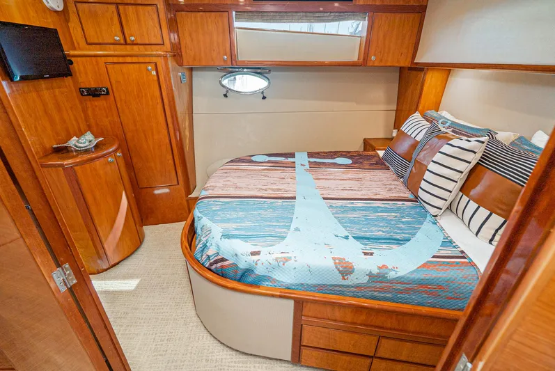 Nick Of Time Yacht Photos Pics Luxurious 2007 Midnight Lace Sport Cruiser cabin with nautical-themed bedding and elegant wood finishes.