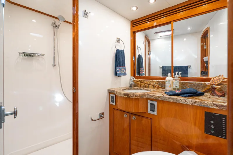 Nick Of Time Yacht Photos Pics Luxurious bathroom in 2007 Midnight Lace Sport Cruiser with marble countertop and modern shower.