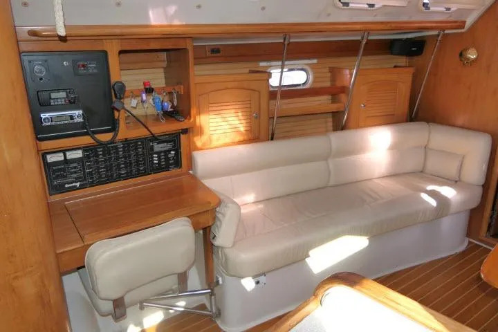 Right Action Yacht Photos Pics Interior of 2008 Catalina 400 MK II sailboat with beige seating and wooden cabinetry.