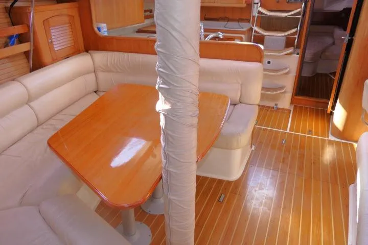 Right Action Yacht Photos Pics Interior of 2008 Catalina 400 MK II sailboat with wooden flooring and cozy seating area.