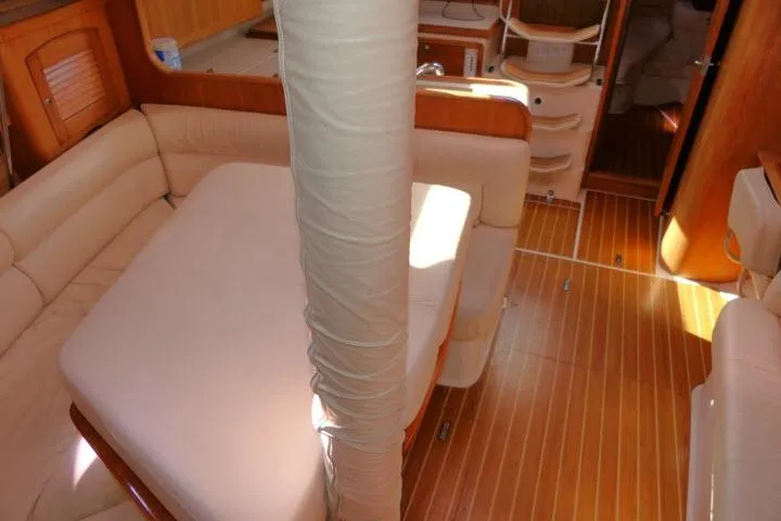 Right Action Yacht Photos Pics Interior of 2008 Catalina 400 MK II sailboat with wooden flooring and cushioned seating.