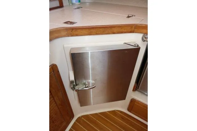 Right Action Yacht Photos Pics 2008 Catalina 400 MK II yacht interior with stainless steel cabinet and wooden accents.