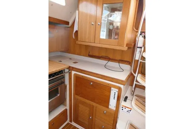 Right Action Yacht Photos Pics 2008 Catalina 400 MK II yacht interior kitchen with wooden cabinets and countertop.