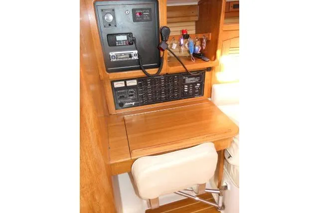 Right Action Yacht Photos Pics Navigation station of 2008 Catalina 400 MK II sailboat with control panel and seating.