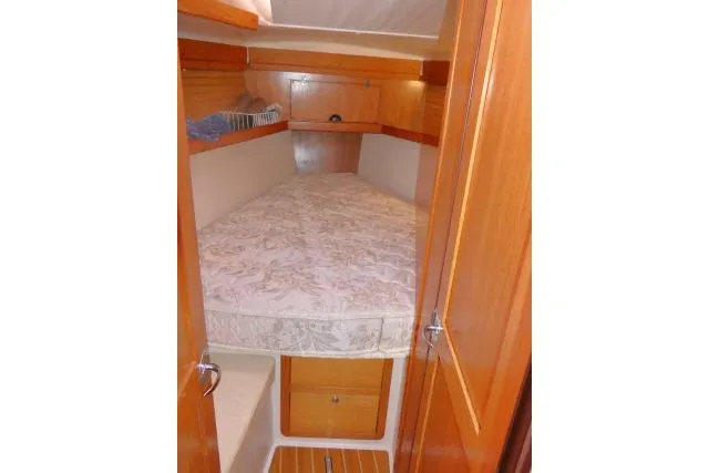 Right Action Yacht Photos Pics 2008 Catalina 400 MK II yacht cabin with cozy bed and wooden interior.
