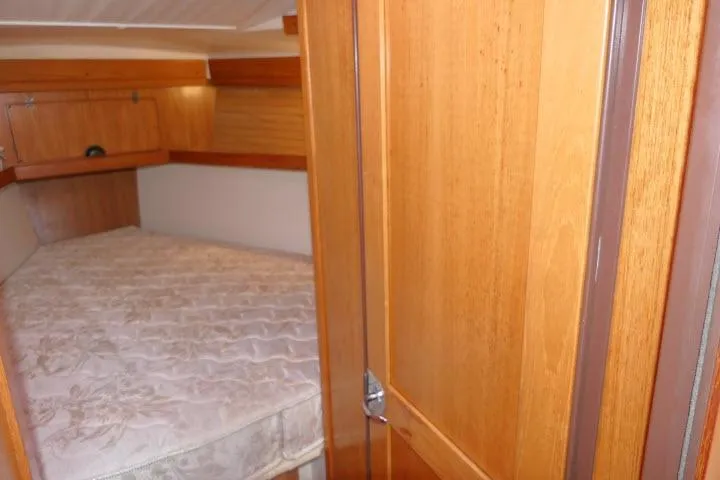 Right Action Yacht Photos Pics 2008 Catalina 400 MK II cabin interior with wooden finish and cozy bed.