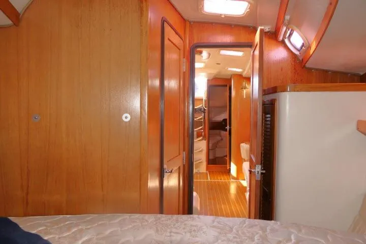 Right Action Yacht Photos Pics Interior of 2008 Catalina 400 MK II sailboat, featuring wooden paneling and cozy cabin layout.