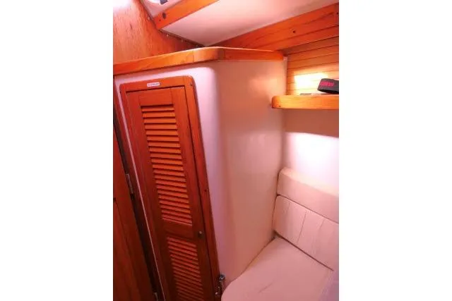 Right Action Yacht Photos Pics 2008 Catalina 400 MK II interior with wooden cabinet and cushioned seating.