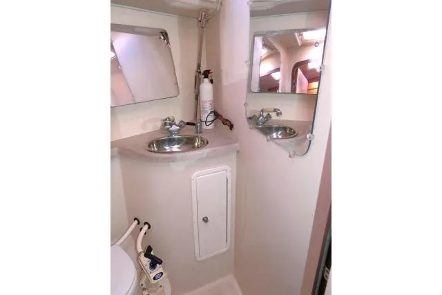 Right Action Yacht Photos Pics 2008 Catalina 400 MK II yacht bathroom with sink, mirrors, and fire extinguisher.