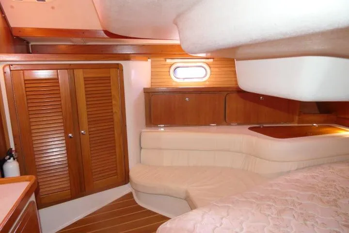 Right Action Yacht Photos Pics Interior of 2008 Catalina 400 MK II yacht with wooden cabinets and cozy seating area.