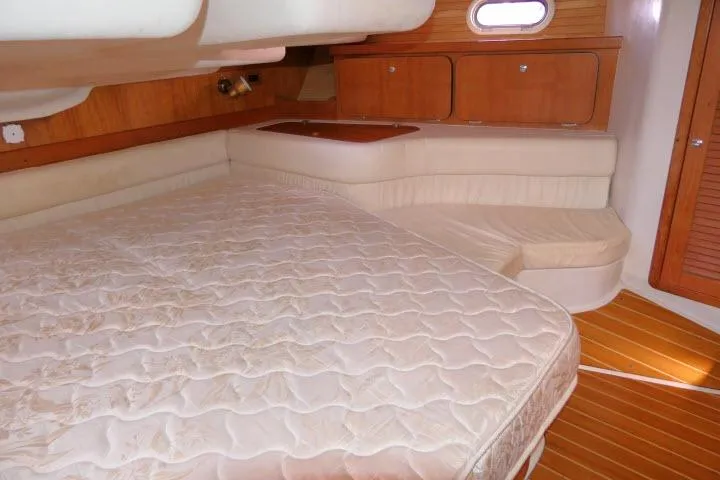 Right Action Yacht Photos Pics Interior cabin of 2008 Catalina 400 MK II sailboat with bed and wooden cabinetry.