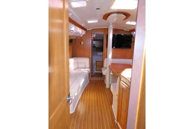 Right Action Yacht Photos Pics Interior of 2008 Catalina 400 MK II yacht with wood flooring and white seating.