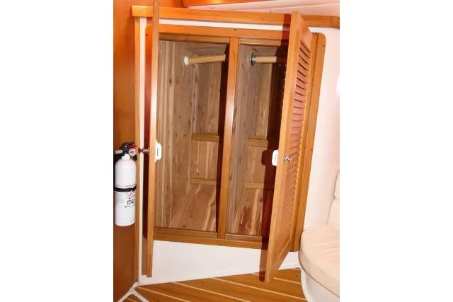 Right Action Yacht Photos Pics Wooden closet interior on 2008 Catalina 400 MK II yacht with fire extinguisher nearby.