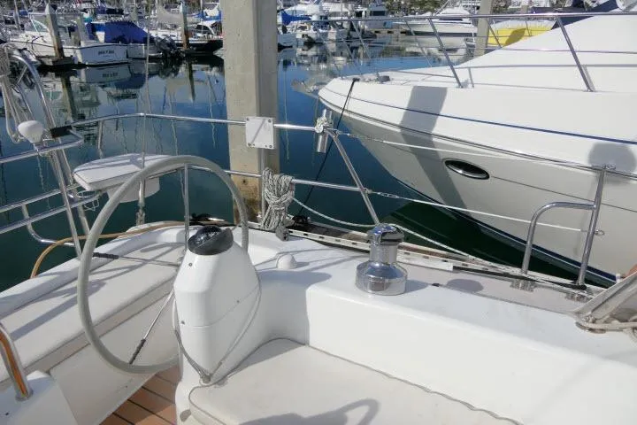 Right Action Yacht Photos Pics 2008 Catalina 400 MK II sailboat cockpit with steering wheel, docked in marina.