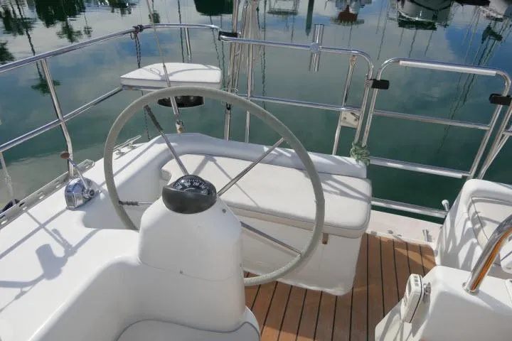 Right Action Yacht Photos Pics Steering wheel of 2008 Catalina 400 MK II sailboat, docked with polished deck.