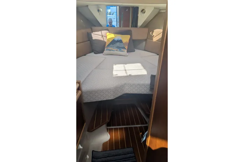 Kameleon Yacht Photos Pics Interior cabin of 2017 Cutwater C-28 boat with cozy bed and decorative pillow.