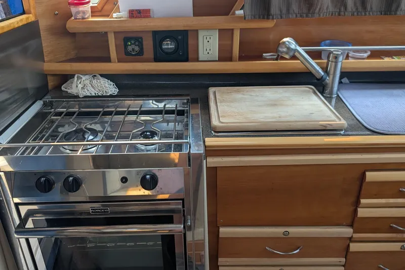 Kameleon Yacht Photos Pics Kitchen area of a 2017 Cutwater C28 boat with stove and sink.