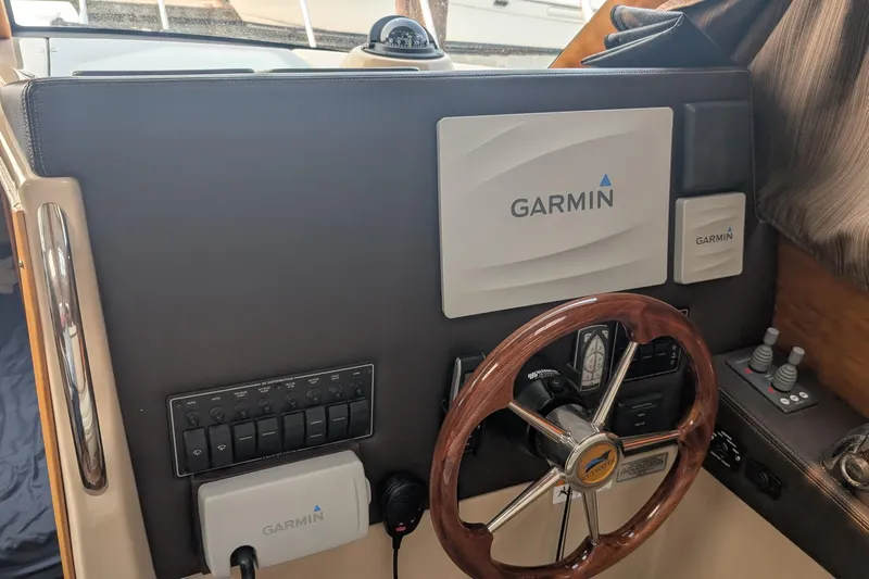 Kameleon Yacht Photos Pics 2017 Cutwater C28 helm with Garmin navigation system and wooden steering wheel.