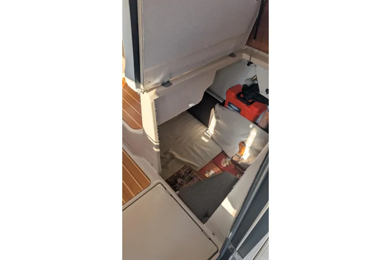Kameleon Yacht Photos Pics 2017 Cutwater C28 interior storage compartment with wooden flooring and equipment.