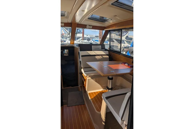 Kameleon Yacht Photos Pics Interior of a 2017 Cutwater C28 boat with seating and table.