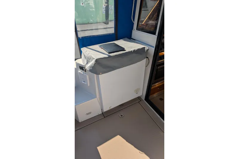 Kameleon Yacht Photos Pics 2017 Cutwater C28 boat interior with covered equipment and open cabin door.