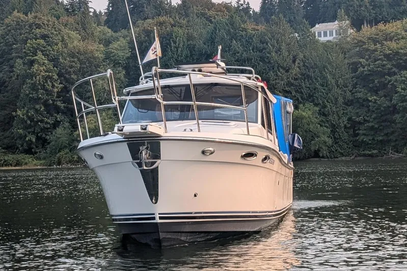 Kameleon Yacht Photos Pics 2017 Cutwater C28 boat on a serene lake with lush forest backdrop.