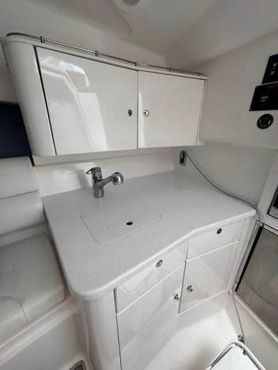 No Name Yacht Photos Pics 2016 Intrepid 375 Walkaround boat interior kitchen with white cabinets and countertop.