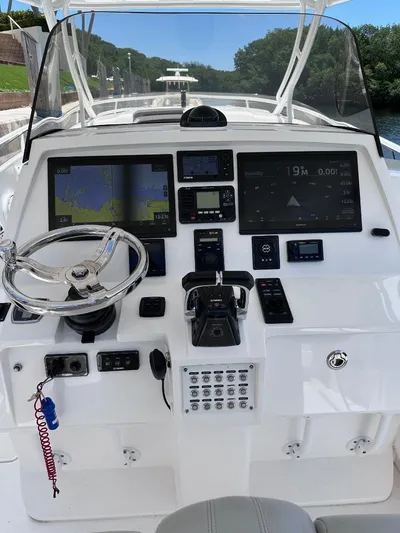 No Name Yacht Photos Pics 2016 Intrepid 375 Walkaround boat dashboard with navigation and control systems.