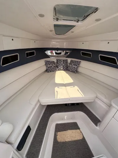 No Name Yacht Photos Pics 2016 Intrepid 375 Walkaround cabin with white seating and decorative pillows.