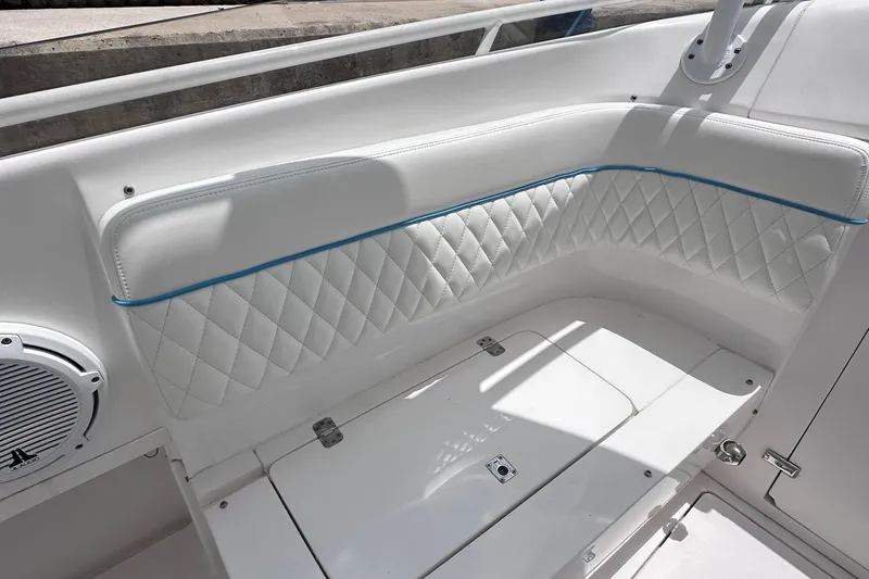 No Name Yacht Photos Pics 2016 Intrepid 375 Walkaround boat interior with white quilted seating and speaker.