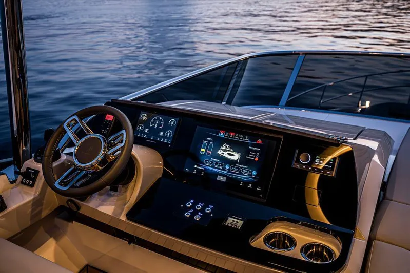 Absolute 52 Fly Yacht Photos Pics Luxurious helm of 2025 Absolute 52 FLY yacht with advanced navigation displays at sunset.