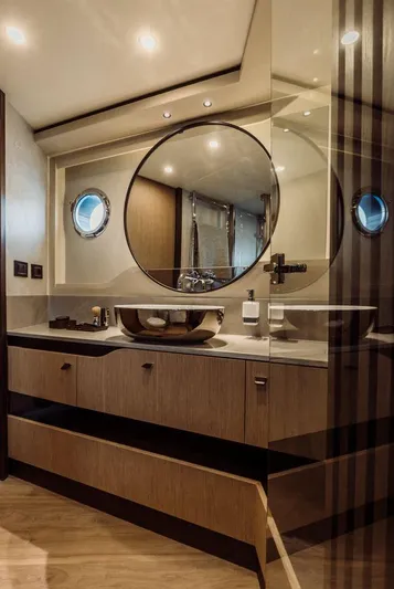 Absolute 52 Fly Yacht Photos Pics Luxurious bathroom in 2025 Absolute 52 FLY yacht with modern fixtures and round mirror.