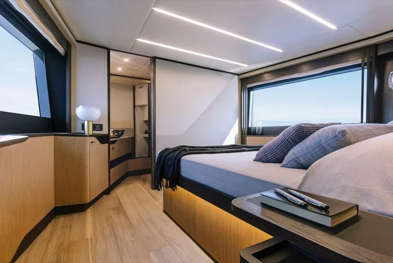 Absolute 52 Fly Yacht Photos Pics Luxurious bedroom interior of 2025 Absolute 52 FLY yacht with modern design and large windows.
