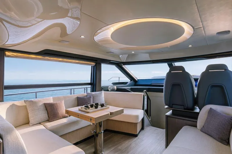 Absolute 52 Fly Yacht Photos Pics Luxurious interior of 2025 Absolute 52 FLY yacht with modern seating and panoramic views.
