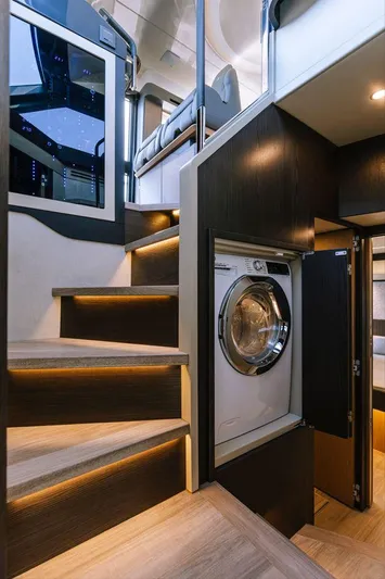 Absolute 52 Fly Yacht Photos Pics Luxurious interior of 2025 Absolute 52 FLY yacht with modern staircase and built-in washer.