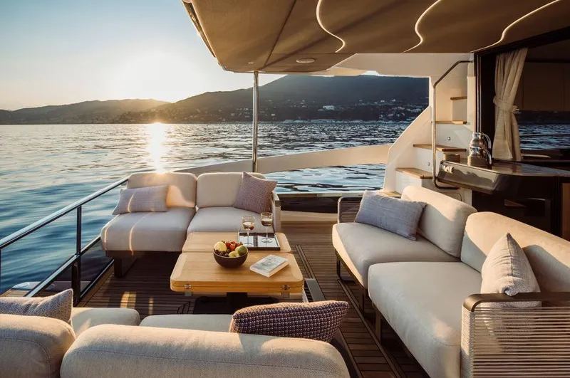 Absolute 52 Fly Yacht Photos Pics Luxurious 2025 Absolute 52 FLY yacht deck with sunset view and comfortable seating.