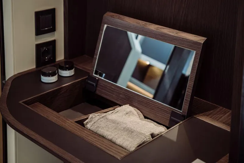 Absolute 52 Fly Yacht Photos Pics Luxurious vanity area on 2025 Absolute 52 FLY yacht with mirror and toiletries.