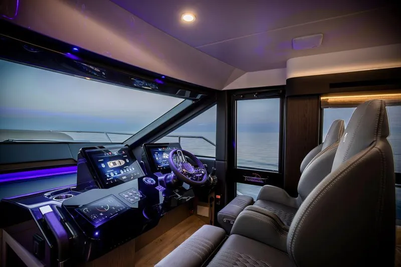 Absolute 52 Fly Yacht Photos Pics Luxurious interior of 2025 Absolute 52 FLY yacht cockpit with modern controls and ocean view.