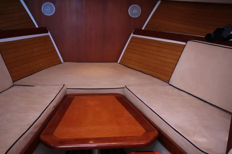  Yacht Photos Pics Interior of 2007 Back Cove 29 boat with cushioned seating and wooden table.