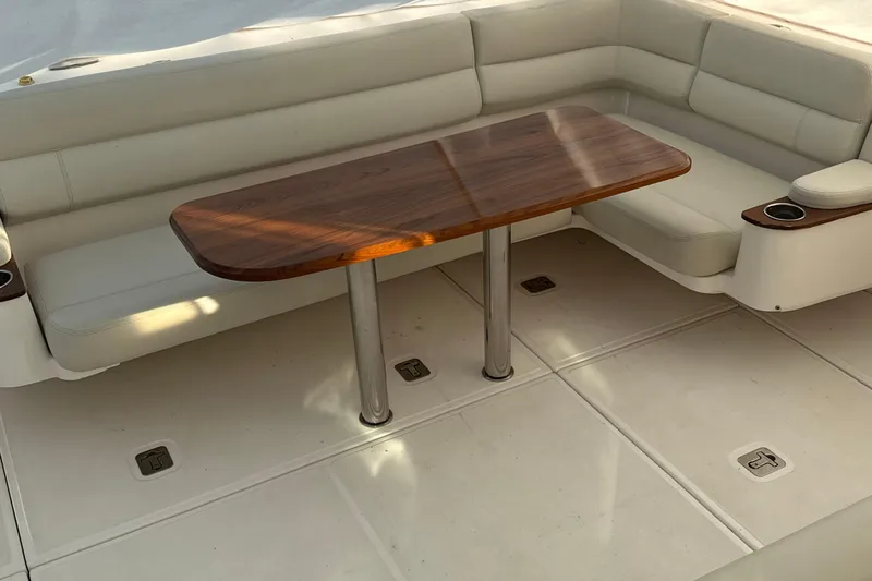 Nomad Yacht Photos Pics 2019 Tiara Yachts 39 Open interior with cushioned seating and wooden table.