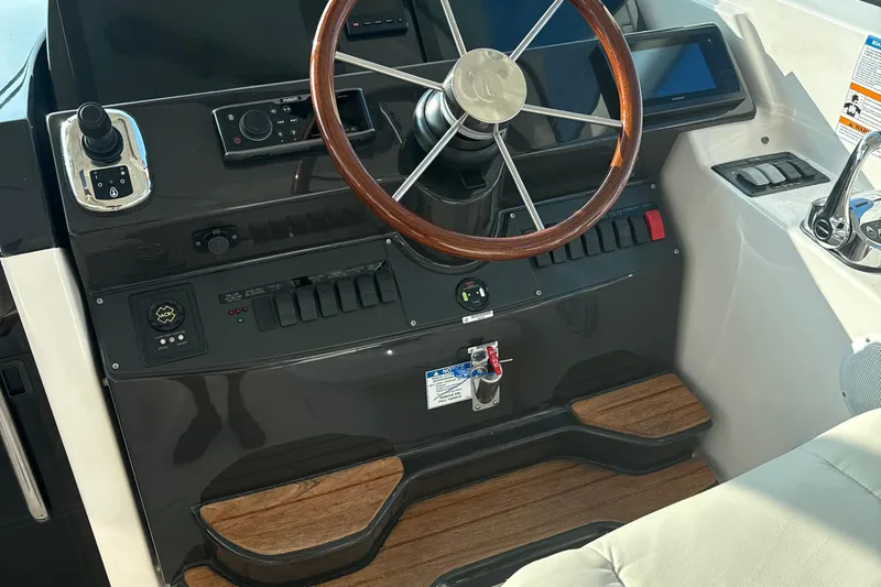 Nomad Yacht Photos Pics 2019 Tiara Yachts 39 Open helm with wooden steering wheel and modern controls.
