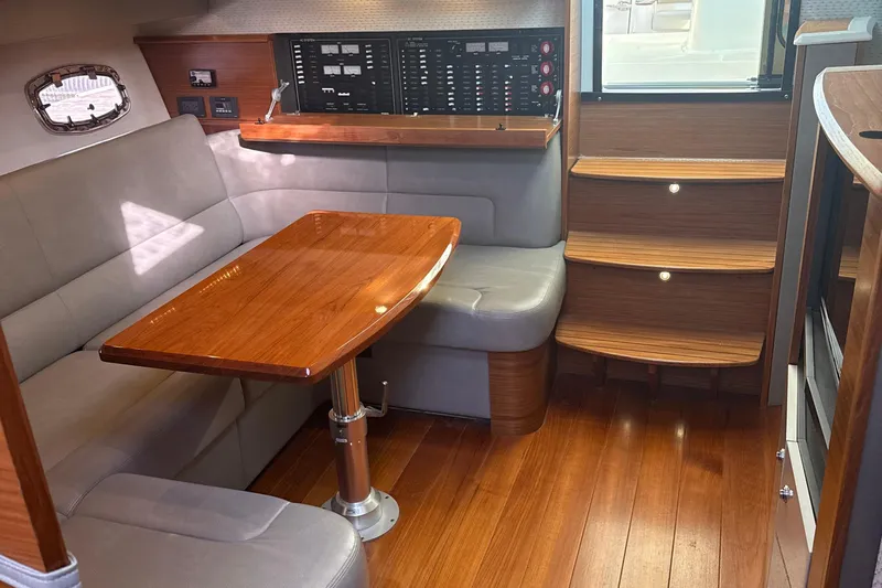Nomad Yacht Photos Pics 2019 Tiara Yachts 39 Open interior with wood table, seating, and control panel.