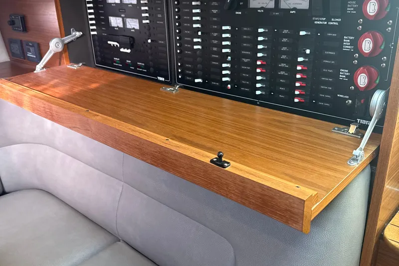 Nomad Yacht Photos Pics Control panel of 2019 Tiara Yachts 39 Open with wooden cover and switches.