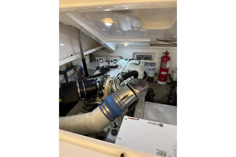 Nomad Yacht Photos Pics Engine room of 2019 Tiara Yachts 39 Open, featuring modern equipment and fire extinguisher.