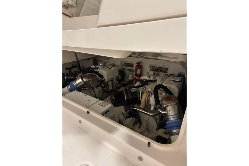 Nomad Yacht Photos Pics Engine compartment of 2019 Tiara Yachts 39 Open, showcasing dual engines and components.