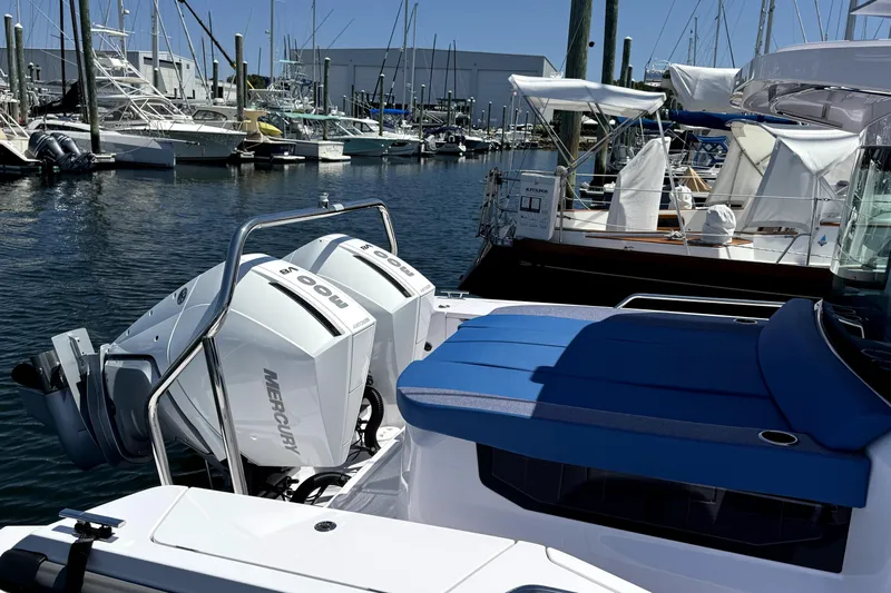  Yacht Photos Pics 2024 Axopar 37 XC CROSS CABIN with twin Mercury engines docked at a marina.