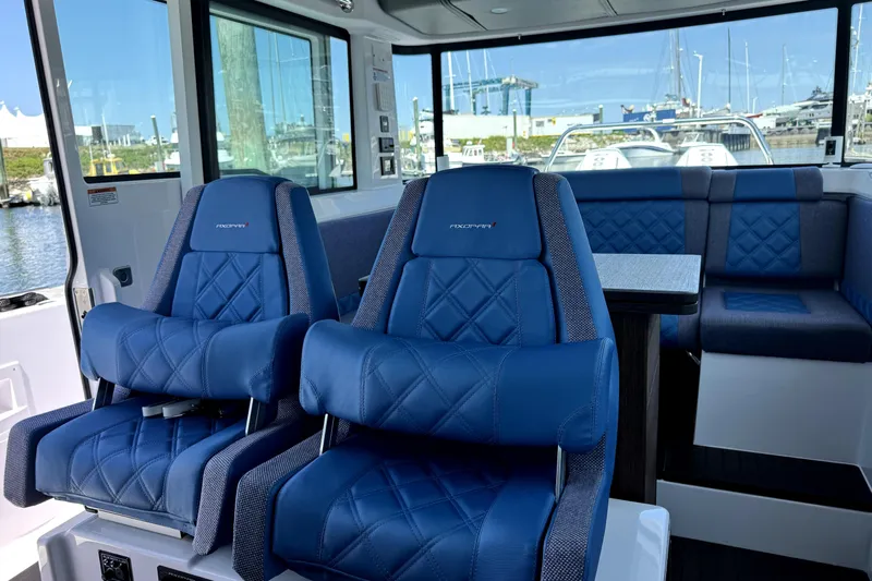  Yacht Photos Pics Interior of 2024 Axopar 37 XC CROSS CABIN with blue seating and table.